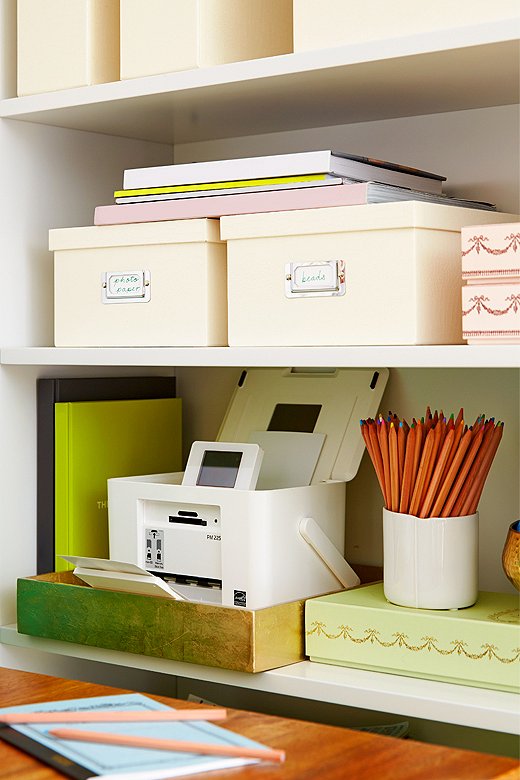 

Dress up neutral storage boxes on shelves by mixing in some pretty repurposed candy boxes, metallic bowls, and a few colorful books.


 
 
